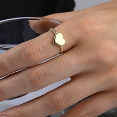 This gorgeous, delicate 14-carat gold band features a tiny gold heart. Its simple and elegant design makes it the perfect everyday piece or thoughtful gift for someone special.  RING DETAILS ♥ Gold Material: 14K Solid Gold ♥ Design: Minimalist rope band with a small heart ♥ Gold Color Options: 14K yellow gold, 14K white gold, or 14K rose gold ♥ Craftsmanship: 100% Handmade and made to order ♥ Versatility: Perfect for daily wear or special occasions ♥ 100 % Handmade ♥ Made to Order CUSTOMISATION DETAILS ♥ Choose your colour: 14K Yellow gold 14K White gold 14K Rose gold ♥ Select your ring size.  Use our ring size conversion table to convert your ring size according to your country of residence. PROCESSING & SHIPPING We know you're excited to get your hands on your order, and we're just as ex Ring Heart Shape, Twisted Band Ring, Rope Ring, Rope Rings, Gold Heart Ring, Ring Heart, Love Jewelry, Special Ring, Twisted Band