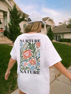 ✺ NURTURE NATURE - WILDFLOWER GRAPHIC TEE ✺ * Q U I C K F A C T S * This design is a unique, one-of-a-kind awesome illustration that has been created in house. ✺ 100% Cotton (fiber content may vary for different colors) ✺ Classic fit ✺ Sizing is unisex so runs like men's, though not overly large ✺ Most women find their typical size works best, since they are meant to fit a touch loose This is a Unisex T-Shirt which you can use as an Oversize T-Shirt Dress, please check the dimensions to make sur Mother Nature Tshirt, Graphic Tee Photography, White Floral Print Relaxed Fit Shirt, Spring Tops With White Screen Print, White Print Screen Printed Tops For Spring, Spring White Print Screen Printed Tops, White Printed Screen Print Tops For Spring, Spring White Print Screen-printed Tops, Multicolor Screen Print Shirt For Spring