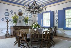 a formal dining room with blue and white walls