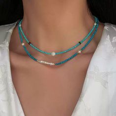 This delicate necklace brings together the serenity of turquoise beads with the subtle shimmer of moonstone. Each piece is meticulously crafted with natural freshwater pearls and blue turquoise accents, offering a unique combination of textures and colors. The adjustable chain ensures a comfortable fit, making this necklace perfect for layering or wearing on its own for a minimalist, chic look. Details Material: 24K gold-plated brass, natural freshwater pearls, turquoise, and moonstone Length: 46cm, 47cm, 46cm (with 5.5cm extension) Weight: Approx. 5.3g, 7.0g, 8.0g Style: Elegant and versatile, perfect for both casual and formal occasions Care Tips: Avoid exposure to harsh chemicals and keep dry to maintain its beauty Missy Jewelry Natural Stone Necklace Collection Blue Double Strand Beaded Pearl Necklace, Turquoise Pearl Necklace With Natural Stones, Blue Bohemian Pearl Necklace With Gemstone Beads, Bohemian Blue Pearl Necklace With Gemstone Beads, Blue Bohemian Jewelry With Pearl Charm, Bohemian Blue Jewelry With Pearl Charm, Turquoise Beaded Necklace With Pearl Charm As Gift, Turquoise Pearl Necklace With Gemstone Beads, Blue Bohemian Pearl Necklaces