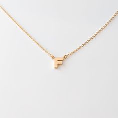 The initial necklace you loved as a child, made for grown-up you. Available in A-Z, this petite letter necklace adds a personal touch to any look. For the ultimate gesture of devotion, wear the initial of someone you love along with your own.14k gold plated tiny letter charm on 1.2mm Rae cable chain. Adjustable between 14-16". Shop our 14k Fine version HERE Neck Stack, Script Necklace, Thick Layers, Back Necklace, Letter Charm, Anklet Bracelet, Letter Charms, Charm Set, Letter Necklace