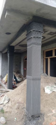 an old pillar in the middle of a building under construction