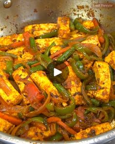 a pan filled with tofu and vegetables on top of a stove