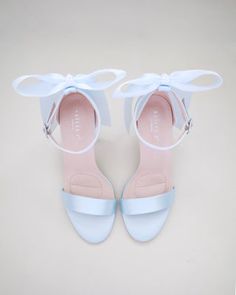 a pair of blue and white shoes with bows