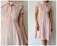 Cute fifties or early sixties dress. This dress is made out of a soft and shiny jaquard woven pink fabric. There is a large collar with bow, a fitted bodice and a pleated skirt. There is a zipper on the back and the collar opens with snap buttons to allow the zip to open all the way. Cute dress is good condition, would fit best for a size S, check out the measurements for additional sizing information Model is a size xs/s and 1,70m tall,all measurements taken flat, double for circumference. Armp Pink Daywear Dresses With Bow, Feminine Pink Dress With Peter Pan Collar, Summer Formal Dress With Peter Pan Collar, Pink Retro Dress With Peter Pan Collar, Pink Fitted Dress With Peter Pan Collar, Vintage Pink Collared Dress, Pink Vintage Collared Dress, Retro Pink Collared Dress, Sixties Dress