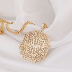 14 K Solid Gold Sriyantra Necklace, Sri yantra Charm Necklace, Hindu jewelry , Gold Mandala Necklace, Sri Charka Necklace  * Gender : Male / Female * Material : Solid Gold and 925 Sterling Silver  * If you prefer a 14k solid gold, we will send a 40 cm 14 carat gold chain weighing 1-1.5 grams. * If you prefer a Silver necklace, we will send you a 50cm silver chain.  * If you prefer a 14k solid gold with triple chains, we will send you the lengths of 37/45/50cm that are presented in the models.  * If you prefer a sterling silver necklace with triple chains, we will send you 37/45/50cm Silver chain.  * 3-piece chain length is standard and suitable for all women        * Visit our shop for more items   https://luminousluxurycrafts.etsy.com    ✔ Ready to Ship in 1-2 Business Days ✔ Free shippin Hindu Jewelry, Schmuck Gold, Mandala Necklace, Sri Yantra, Gold Mandala, Gold Locket, Jewellery Sets, Jewelry Lookbook, Bridal Gold Jewellery