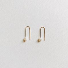 + PEARL U HOOP THREADER EARRINGS +Tiny Fresh Water pearl threader in U shape made with 14k Gold-filled wires. A small drop dangle on your ears that are modern & classic. + Fresh water pearls 4mm+ 14k Gold-filled wire+ Listing is for 1 pair of earrings+ Please allow 5-7 business days to ship out. Minimalist Pearl Earrings For Everyday, Minimalist Everyday Pearl Earrings, Adjustable Minimalist Threader Earrings For Everyday, Minimalist Pearl Drop Earrings For Everyday, Everyday White Threader Earrings, Everyday 14k Gold Filled Pearl Earrings With Ear Wire, Minimalist Dangle Threader Earrings With Pearl Charm, Minimalist Pearl Drop Threader Earrings, Everyday White Pearl Drop Threader Earrings