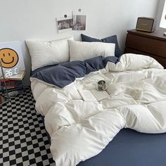 an unmade bed with white sheets and pillows on top of it in a bedroom