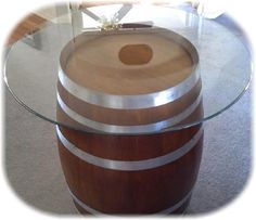 a glass table with a wooden barrel on top