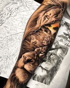 a man's arm with an image of lions on it and the sun in the background