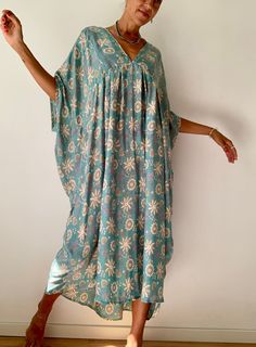 "This is one of a kind oryginal oversized flared tunic Soft comfy fabric, with floral print makes it very lively summer maternity dress Really comfortable loose silky and flowy in blue colour This style is timeless,  easy covers different body shapes  MEAESURE XL shoulder 19 bust 46\" length 50\" MATERIAL *upcycled saree silk  * no lining  For more boho style ideas please visit also  https://www.etsy.com/uk/shop/Gyaki CARE INSTRUCTIONS  * Wash in warm water * Hand wash recommended * Hang to dry Spring Festival Lagenlook Dresses, Oversized Chic Dress For Beach Cover-up, Blue Oversized Summer Dress, Oversized Blue Summer Dress, Bohemian Floral Print Relaxed Fit Dress, Bohemian Relaxed Fit Floral Print Dress, Flowy Floral Print Maxi Kaftan, Bohemian Floral Print Relaxed Dress, Bohemian Batwing Sleeve Spring Dresses