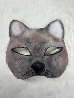 This is one of my newer masks, a siamese cat! It is a high quality mask made from a cat mask base.  Mask Features: * Designed with eyeshadow for an airbrushed look * Clay nose add on * Felted Note: This product is made with a paper base, and therefore will mold if it gets wet and not dried properly. Please be careful not to bring this product near water! If you have any questions, feel free to reach out! Cat Design Eye Mask For Costume Party, Cat Design Eye Mask For Masquerade, Masquerade Eye Mask With Cat Design, Cat Ears Masks With Whiskers For Masquerade, Cat Design Eye Mask For Costume, Cat Design Costume Eye Mask, Costume Cat Design Eye Mask, Masquerade Cat Ears Mask With Whiskers, Masquerade Mask With Whiskers