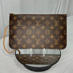 Authentic Louis Vuitton Monogram Neverfull Pouch/Wristlet Nwot. What A Beauty! Brand New Without Tags, Never Been Used. Gold Tone Brass Zipper Rail, Zipper Pull And Clutch Lock. No Patina On The Vachetta Leather. Perfect Brown Pinstripe Cloth Interior. Serial Number Sd4186. Approximately 9.75” L & 6” H If You Have Any Questions, Please Feel Free To Reach Out / Comment Below. Luxury Clutch With Removable Pouch In Monogram Canvas, Luxury Monogram Canvas Clutch With Removable Pouch, Monogram Canvas Clutch With Removable Pouch, Designer Monogram Canvas Clutch, Monogram Canvas Clutch For Daily Use, Daily Use Monogram Canvas Clutch, Designer Monogram Canvas Pouch Clutch, Brown Monogram Canvas Clutch, Louis Vuitton Monogram Neverfull