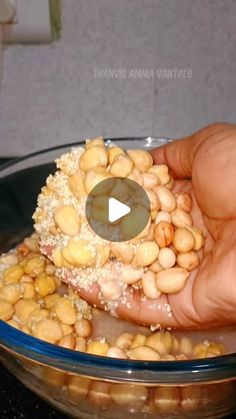 a person holding food in their hand over a bowl filled with beans and rice,