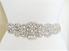 "Wedding Belt, Bridal Sash Belt - SILVER Crystal Pearl Wedding Sash Belt Applique size - approximately 25\" long and 2 1/2\" wide. (widest point). ** Self tie ribbon ties in the back. Total sash belt is measuring about 3.5 yards, 7/8\" width wide. ** Double face satin ribbon colors are available in White, Off White, Ivory, Black, Navy and Silver Grey. Please select the sash color from the drop down menu **Due to all products being hand made, there will be a natural variance from product to produ Bridal Sash Belt, Wedding Belt, Wedding Sash Belt, Rose Gold Accents, Wedding Sash, Rhinestone Belt, Bridal Sash, Wedding Belts, Sash Belts