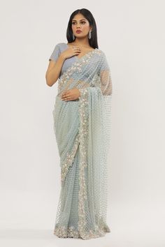 Blue saree featuring sequin and crystal embroidered floral jaal motifs on border with floral bead buttis. Comes with lace work blouse.
Components: 2
Pattern: Embroidered
Type Of Work: Crystal,Sequin
Neckline: V-neck
Sleeve Type: Half
Fabric: Saree: Net, Blouse: Organza
Color: Blue
Other Details: 
Saree cut-out edges
Closure: Blouse: Side zip
Occasion: Destination Wedding,Wedding - Aza Fashions Crystal Saree, Saree Net, Blouse Organza, Net Blouse, Net Saree, Blue Saree, Blouse For Women, Fashion App, Blouse Online