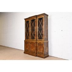 an old wooden bookcase sitting against a white wall