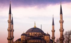 a large building with two towers and three spires