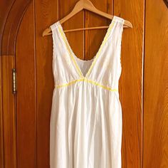 Dreamy 1960s ankle length nightgown w/ plunging neckline & empire waist. The deep V bodice features a whimsical daisy print & is lined w/ matching yellow rick-rack trim. Delicate waist tie extends from empire waist for a more secure & flattering fit. Labeled size S. A quintessential piece of mid-century lounge wear, made by Saks Fifth Avenue. Please reference flat Measurements provided below for fit.  Measurements: Pit to Pit- 17.5"  Empire Waist- 15.75" (w/ back tie for adjustment) Full Length- 52" (40" skirt length, 12" bust length from top of shoulder to center empire waist) Bust Cup- 7.5" wide & 12" long each Condition: In excellent vintage condition. No flaws to note. *All items are vintage & may show natural signs of wear. Any significant flaws will be noted. Price includes the secur V-neck Lined Maxi Dress For Daywear, White V-neck Loungewear Dress, Summer Vacation Nightgown With Lace Trim, White V-neck Maxi Dress For Loungewear, White V-neck Sleepwear For Summer, Spring Cotton V-neck Nightgown, Fitted V-neck Summer Sleepwear, Daywear V-neck Lined Maxi Dress, Spring V-neck Nightgown With Lace Trim