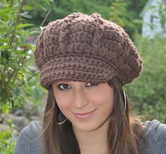 a young woman wearing a brown crocheted hat