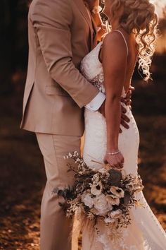 a bride and groom kissing in the sun