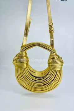 Embrace the allure of the Gold Serpentine Rope Hobo Bag, where elegance entwines with a modern twist. Crafted from sumptuous faux leather with a unique roped design, this bag boasts a shimmering Gold palette that captures the light with every move. Sling it over your shoulder for an instant infusion of sophistication to any outfit. 10W x 7H x 2DOrder ships within 24-48 hours or sooner (Monday-Friday) Final sale removable String *Product color as seen on a monitor may vary slightly compared to ac Belt Ring, Casual Beach Wear, Gold Palette, Screen Color, Hobo Handbag, Gold Handbags, Photography Lighting, Hobo Handbags, Color Calibration