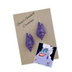 URSULA THE SEA WITCH EARRINGS - PERFECT FOR YOUR URSULA COSTUME! These natural seashells I have painted purple to replicate Ursula's earrings.  Choose from plain or glittered. These are great for an Ursula cosplay or just for anyone who is a Little Mermaid lover!. Thank you for viewing and please do not hesitate to contact me if you have any questions! Visit my shop here for more Seashell Creations:  https://www.etsy.com/au/shop/SusysSeashells?ref=hdr_shop_menu Ursula Cosplay, Ursula The Sea Witch, Ursula Necklace, The Sea Witch, Ursula Costume, Mermaid Crown, Witch Earrings, Mermaid Lover, Sea Witch