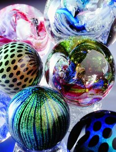 several different colored glass balls sitting on top of each other