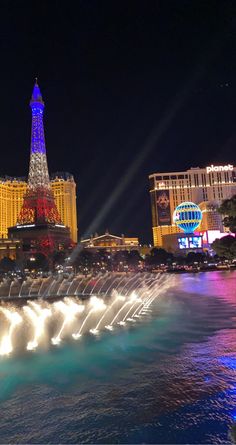 the eiffel tower is lit up at night in las vegas, nv