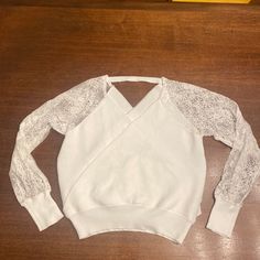 Shein White Sweater Blouse With Lace Long Sleeves. Size L. Never Worn, Pure White, No Blemishes! V Neck On Both Front And Back. Casual Stretch Blouse With Lace Patchwork, V-neck Lace Patchwork Top For Fall, Casual Long Sleeve Tops With Lace Patchwork, Casual White Tops With Lace Patchwork, Casual White Top With Lace Patchwork, Casual White Lace Patchwork Top, Chic Crew Neck Top With Lace Sleeves, White Stretch Tops With Lace Patchwork, White Long Sleeve Tops With Lace Sleeves