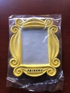 a yellow frame sitting on top of a plastic bag with the word friends written in it