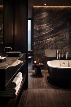 a bathroom with marble walls and flooring next to a bathtub in the middle