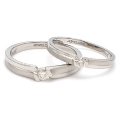 Platinum Love Bands by Jewelove This pair has matte finish majorly with hi-polish on the sides. Each of the rings has a single diamond. Women's band details : Platinum purity : 95% Platinum stamp : Pt950 Platinum certificate : Platinum Guild International Diamond count : 1 Diamond weight : 0.09 cts. Diamond clarity : VS Diamond color : J Diamond setting : Embedded Setting Diamond Grading Report : SGL Men's band details : Platinum purity : 95% Platinum stamp : Pt950 Platinum certificate : Platinu Modern Channel Set Promise Rings, Modern Couple Rings With Diamond Cut For Promise, Modern Channel Set Wedding Rings, Polished Diamond Couple Rings For Wedding, Classic Couple Rings With Diamond Accents For Wedding, Minimalist Platinum Anniversary Ring, Modern Diamond Couple Rings For Formal Occasions, Wedding Couple Rings With Polished Diamond, Classic Wedding Couple Rings With Single Diamond