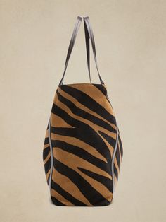 An everyday, carryall tote gets a luxurious update thanks to zebra-printed haircalf leather (also known as "pony"), constructed with plenty of room for a laptop, water bottle and all the essentials.  LEATHER WORKING GROUP: By purchasing this product, Black Zebra Print Bag For Daily Use, Black Zebra Print Bags For Daily Use, Everyday Use Zebra Print Tote Bag, Everyday Use Zebra Print Shoulder Bag, Everyday Zebra Print Tote Bag, Everyday Zebra Print Shoulder Bag, Travel Zebra Print Rectangular Bag, Rectangular Zebra Print Travel Bag, Travel Rectangular Zebra Print Bag