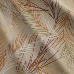 an orange and green leaf pattern on fabric