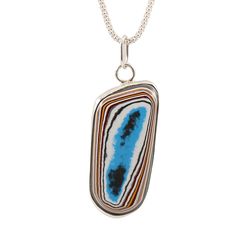 Handmade Fordite necklace Stunning Fordite piece set in sterling silver, open back step bezel. Fordite dates back to the 1920's when layers upon layers of paint would build up in the bays, eventually needing to be removed. Someone discovered that the dried up paint layers could be cut and polished just like gemstones, resulting in unique colors and patterns, creating stunning one-of-a-kind pieces. Most of the Fordite used today is from the 60's to late 70's since the 1980's is when car manufactu Back Steps, Unique Colors, Sterling Silver Chains, Open Back, Silver Chain, Dates, 925 Sterling Silver, Pendant Necklace, Paint