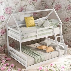 a white bunk bed with pink flowers in the background