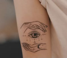 a woman's arm with a tattoo on it and an eye in the middle