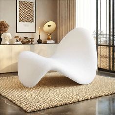 a white chair sitting on top of a rug in a living room