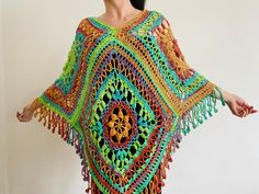 a woman wearing a colorful crocheted shawl