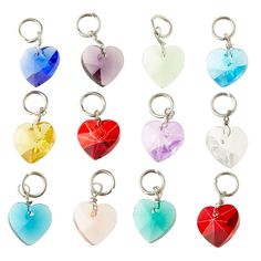 six heart shaped key chains are shown in different colors and shapes, each with a single charm