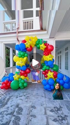 a woman standing in front of a bunch of balloons