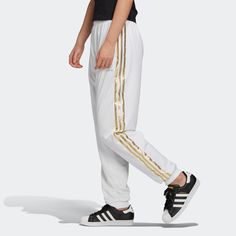 Style: Gk1714 Color: White Gender: Womens * Regular Fit * Drawcord On Elastic Waist * 100% Polyester Tricot * Sporty Track Pants * Side Welt Pockets * Ribbed Cuffs Adidas Athleisure Pants With Elastic Side Panels, Adidas Sportswear Bottoms With Elastic Side Panels, Adidas White Sportswear Bottoms, White Adidas Sports Pants, Sportswear White Pants With Side Stripes, White Sportswear Pants With Side Stripes, Adidas White Streetwear Pants, White Adidas Athleisure Pants, Adidas White Athleisure Pants