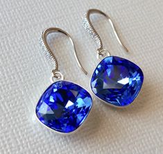 Sapphire Blue Royal Blue Color Cushion Cut Crystal Silver Dangle Wedding Earrings. PLEASE READ ITEM DESCRIPTION and SHOP POLICIES before placing your order, and contact me with any questions! EARRINGS are 1.18 inch (3cm) long from top of earring wire to bottom. BRIDAL EARRINGS SECTION: https://www.etsy.com/shop/LanaChayka?ref=seller-platform-mcnav§ion_id=11638940 BRIDAL JEWELRY SETS SECTION: https://www.etsy.com/shop/LanaChayka?ref=seller-platform-mcnav§ion_id=25839214 BRIDAL NECKLACES SECTION: Blue Crystal Drop Earrings For Formal Occasions, Blue Dangle Crystal Earrings For Formal Occasions, Blue Bridal Earrings For Formal Occasions, Blue Crystal Earrings With Ear Wire For Formal Occasions, Blue Bridal Drop Earrings As A Gift, Blue Drop Earrings For Bridal Formal Occasion, Blue Drop Earrings For Formal Bridal Wear, Blue Drop Earrings For Bridal Gift, Nickel-free Blue Jewelry For Wedding