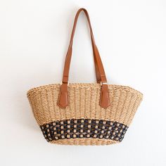 IN STOCK FAST SHIPPING FROM LOS ANGELES Take on the summer with our handmade straw bag! With a large opening and inner pocket, this beach bag is perfect for all your sunny essentials. Simple, durable, and oh-so-cool, this basket bag is the ultimate summer companion. Get ready to turn heads with this unique, stylish statement piece! Plus, it's made with love and care for a unique and stylish statement that's sure to turn heads. Who says functional can't be fun? Get your beach fashion game on point with this versatile and playful bag! High Quality Synthetic Leather Strap Inner Lining with Zipper Closure Size: 7"H x 15"W x 6.5"D Strap drop length: 11" Designer Style ID: 8637 Summer Beach Shoulder Bag Made From Palm Leaf, Basket Beach Bag Made Of Natural Fiber For Vacation, Woven Bucket Shape Shoulder Bag For Beach, Palm Leaf Bags For Everyday Beach Use, Large Capacity Straw Beach Bag In Bucket Shape, Palm Leaf Bags For Everyday Use And Beach Season, Large Capacity Straw Bucket Beach Bag, Palm Leaf Tote Bag For Vacation, Eco-friendly Palm Leaf Shoulder Bag For Vacation