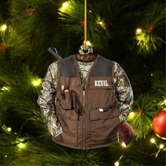 a hunting vest ornament hanging from a christmas tree