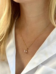 A delicate 14kt gold filled satellite/ball necklace with a clear quartz clover-shaped pendant. A carefully selected high quality clear quartz stone makes this necklace beautiful and one of a kind. Perfect for a gift. The delicate and minimalist design of the necklace goes well with both casual and sophisticated looks.  ✦ MATERIALS ✦  14kt gold filled chain. Genuine clear quartz pendant.  ✦ SIZING ✦  Necklace length: 18 inches Size of the pendant: 10 mm ✦ CLEAR QUARTZ CRYSTAL is known for its harmonizing, balancing and healing attributes. A powerfully protective stone that purifies the wearer on all levels: spiritual, emotional, mental, and physical.  ✦ PACKAGING ✦  All orders are packed in jewelry boxes/pouches with a brand logo, which makes it perfect for gifting. All packaging materials April Birthstone Necklace, Clover Pendant, Healing Necklace, April Birthstone, Ball Necklace, Lucky Clover, Clear Quartz Crystal, Quartz Pendant, Jewelry Boxes