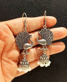 Beautiful Handmade Peacock Oxidised Earrings. Light Weight Earrings. Traditional Earrings. Ethnic Earrings. Silver Plated Earrings. Handmade Earrings. Material- Alloy. Fashion Earrings. Bohemian Danglers With Peacock Design, Bohemian Peacock Design Danglers For Diwali, Bohemian Peacock Danglers For Diwali, Bohemian Metal Earrings With Peacock Design, Traditional Peacock Design Danglers For Party, Traditional Peacock Danglers For Party, Silver Peacock Design Drop Earrings, Bohemian Peacock Design Jhumkas For Gift, Bohemian Peacock Design Jhumkas As Gift