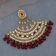 Whether you are the bride or sassy bridesmaid, no lehenga is complete without a Jhumar. This Jumbo size Jhumar/Passa is perfect to steal the show with its glitter and texture.  Gold based filled with crystal stone and beads. Passa Lenth: 13cm width: 13cm approx. Festive Chandbalis With Cutdana For Reception, Festive Cutdana Chandbalis For Reception, Chandbali Zari Work Tikka, Bollywood Style Tikka With Zari Work, Wedding Chandbalis With Tilla, Bollywood Style Tikka For Navratri Festive, Bollywood Style Tikka For Navratri, Festive Bollywood Style Tikka With Pallu, Heavy Kundan Lehenga For Reception