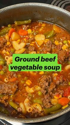 ground beef vegetable soup in a pot on top of an electric stove with the words, ground beef vegetable soup